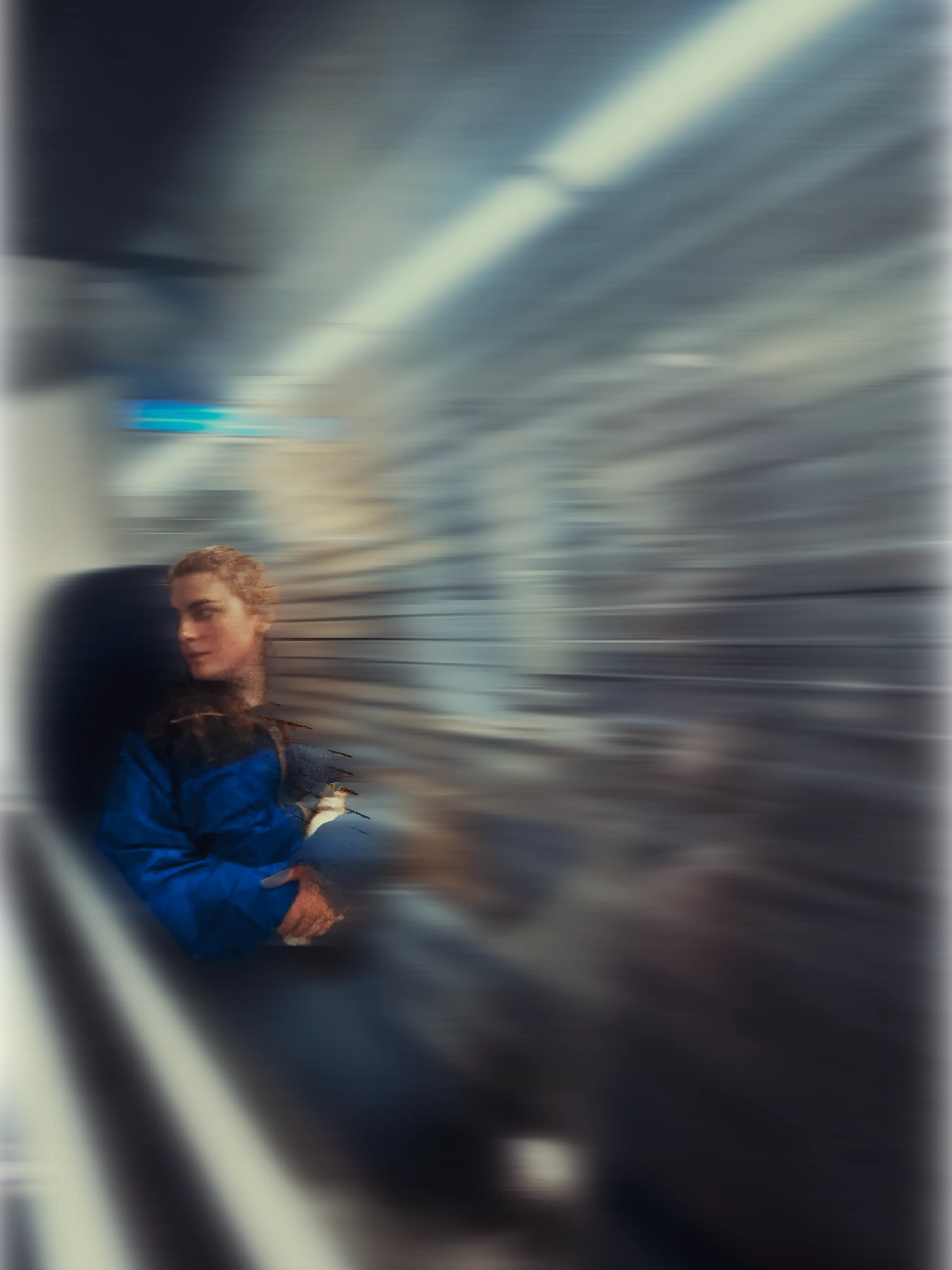 The writer, Erin Page, sitting in a moving train, looking out the window.